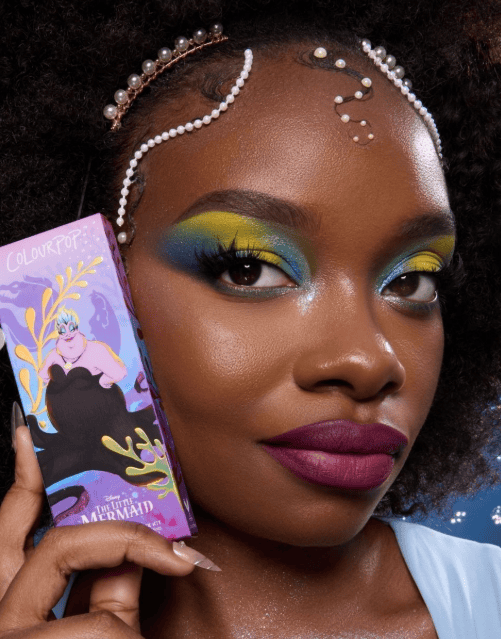Disney Mermaid makeup with vibrant blue, yellow, and green eyeshadow.