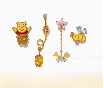 Disney Pooh Bear jewelry with sparkling charms and colorful accents for girls.