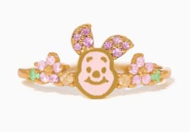 Cute Pooh Bear charm with pink and green floral accents, perfect for kids' accessories.