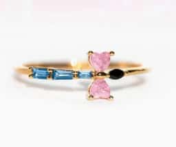 Delicate gold bracelet featuring pink heart and blue gemstone accents, inspired by Winnie the Pooh's.