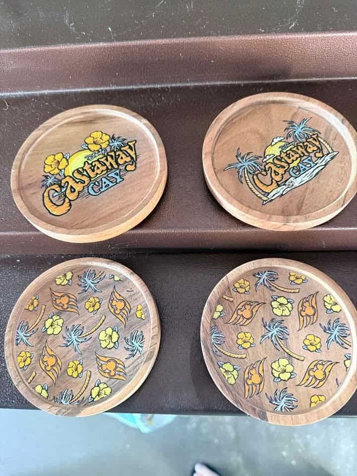 Set of four Disney Cruise Line themed coasters with tropical designs and logo.