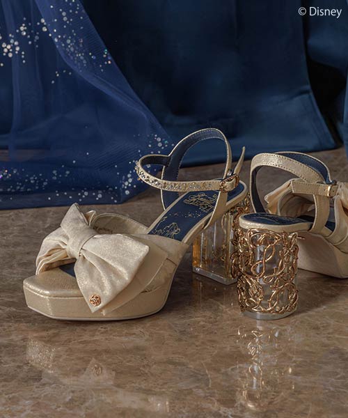 Elegant bridal shoes with bows and gold heels for Disney-themed wedding fashion.