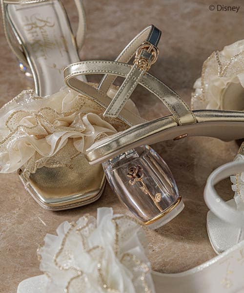 Disney-inspired bridal shoes with floral embellishments and gold accents.