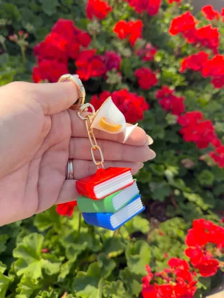 Disney-themed keychain with miniature books and a duck figure.