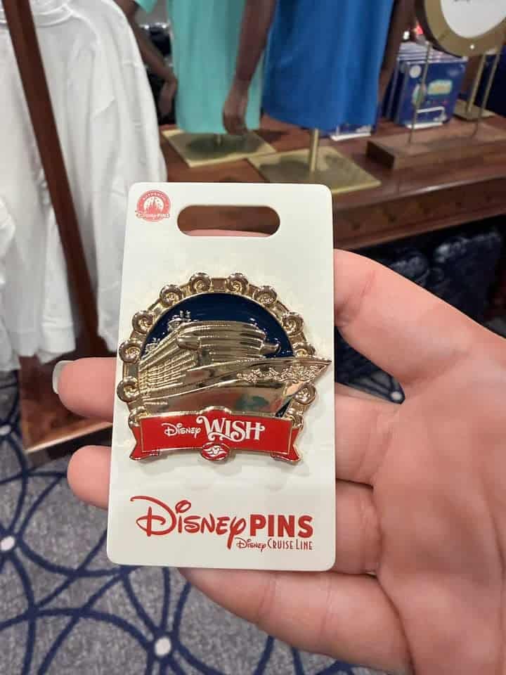 Disney Wish Disney Pins on a card with a gold and blue design.