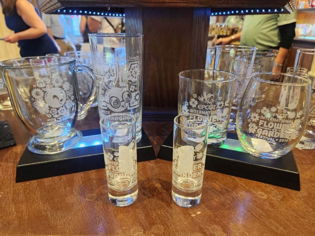 Disney-themed glassware set featuring EPCOT Flower & Garden Festival designs.