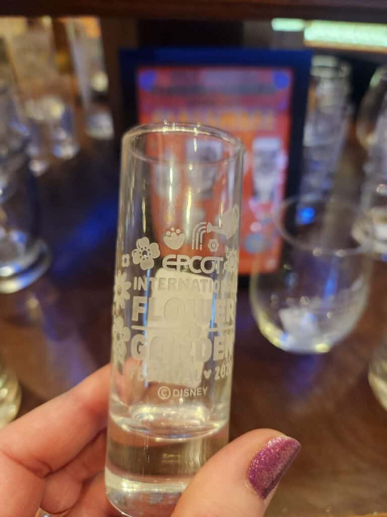 Disney international floral shot glass with Disney logo.