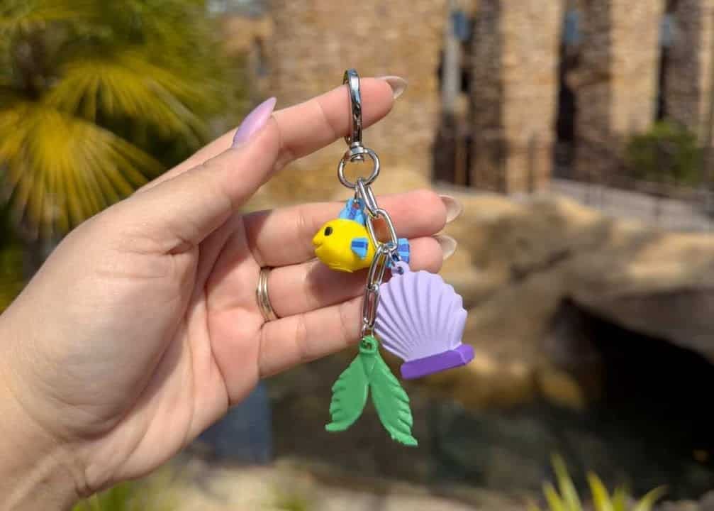 Disney fashion keychain with shell, leaf, and duck charms for fans and collectors.
