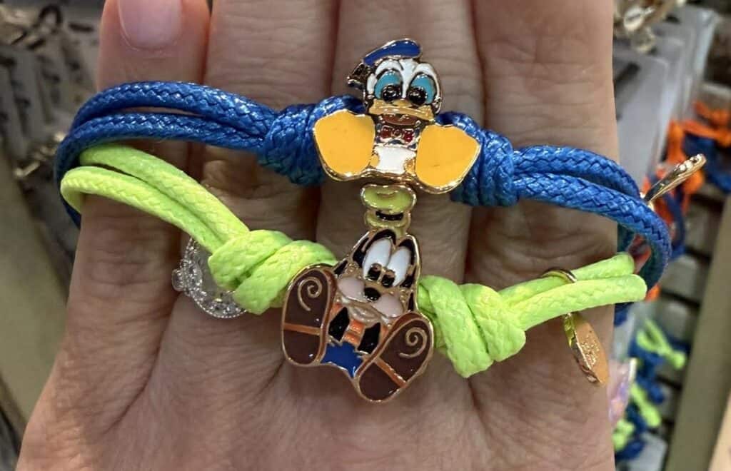 Colorful Disney character bracelets with Donald Duck and Daisy Duck charms.