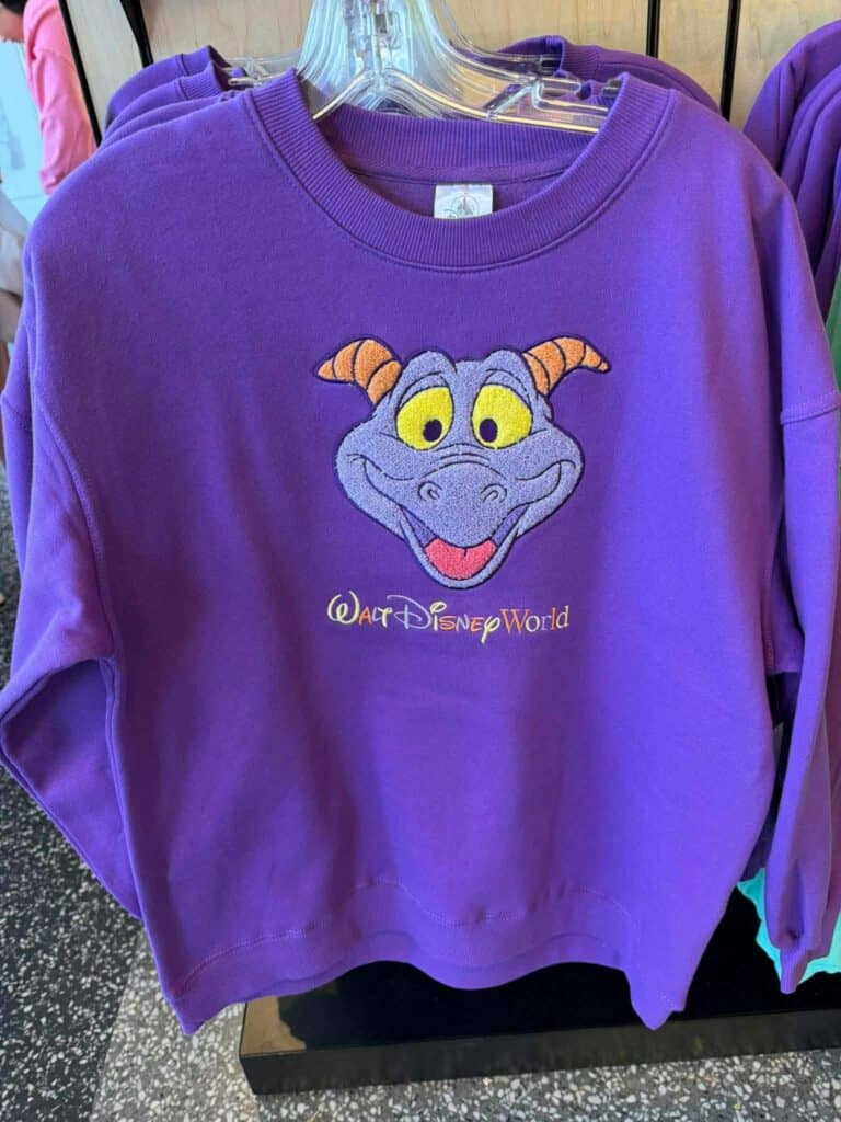 Purple Disney sweatshirt featuring a cute dragon character from Walt Disney World.
