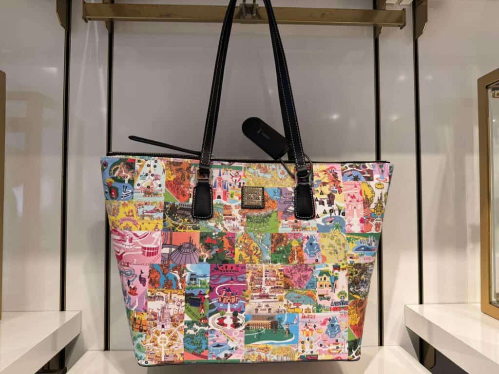 Colorful Disney-themed tote bag with patchwork design and black handles.