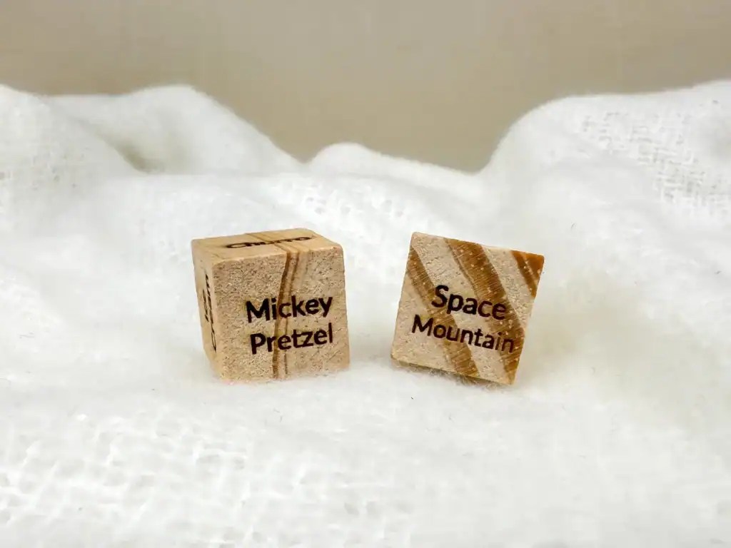 Wooden Scrabble tiles featuring Mickey Pretzel and Space Mountain themes.