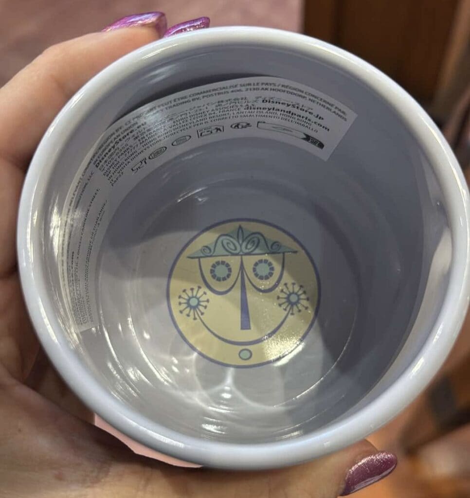 Close-up of a Disney character face design inside a white mug.