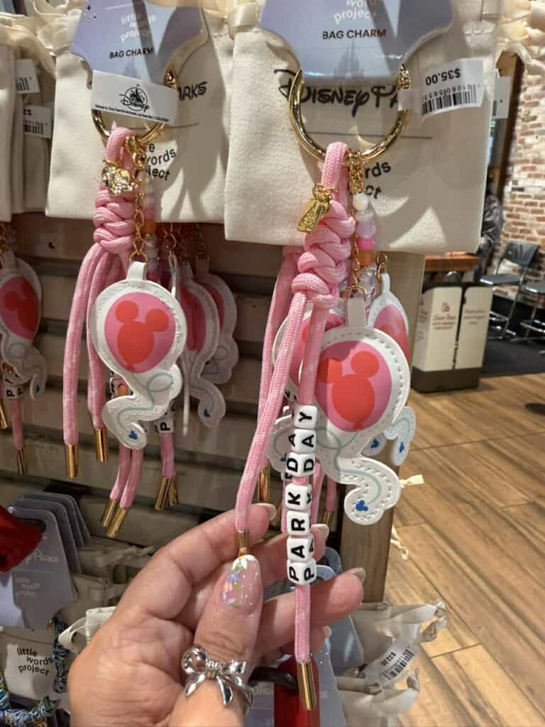 Bracelets featuring Disney-themed charms and "PARK DAY" beads, debuting at Walt Disney World.