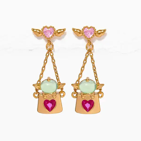 Gold-tone earrings with pink heart, green gem, and dangling bag charms.