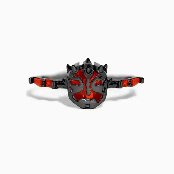 Unique black and red dragon face jewelry piece with detailed design.