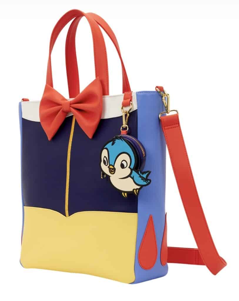 Colorful Disney tote bag with penguin charm and red bow, perfect for fans.