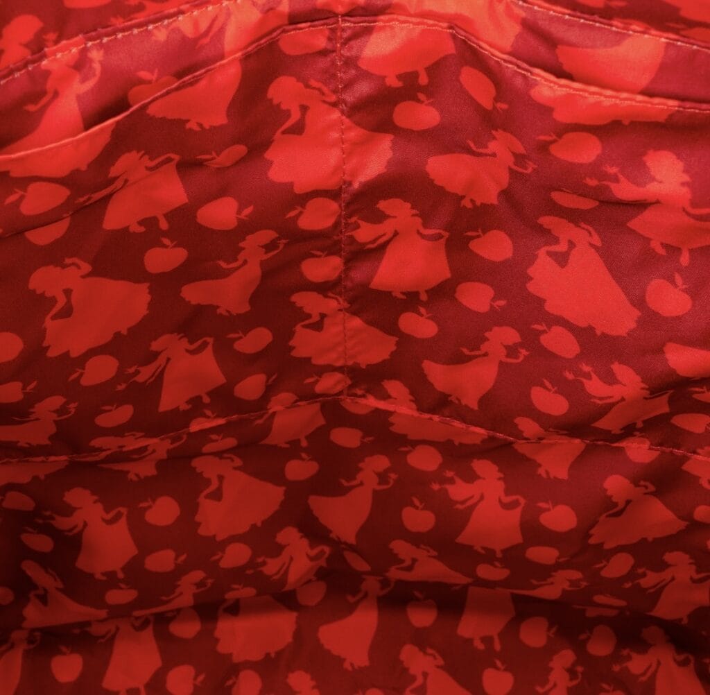 Red fabric with Disney princess silhouettes and hearts design.