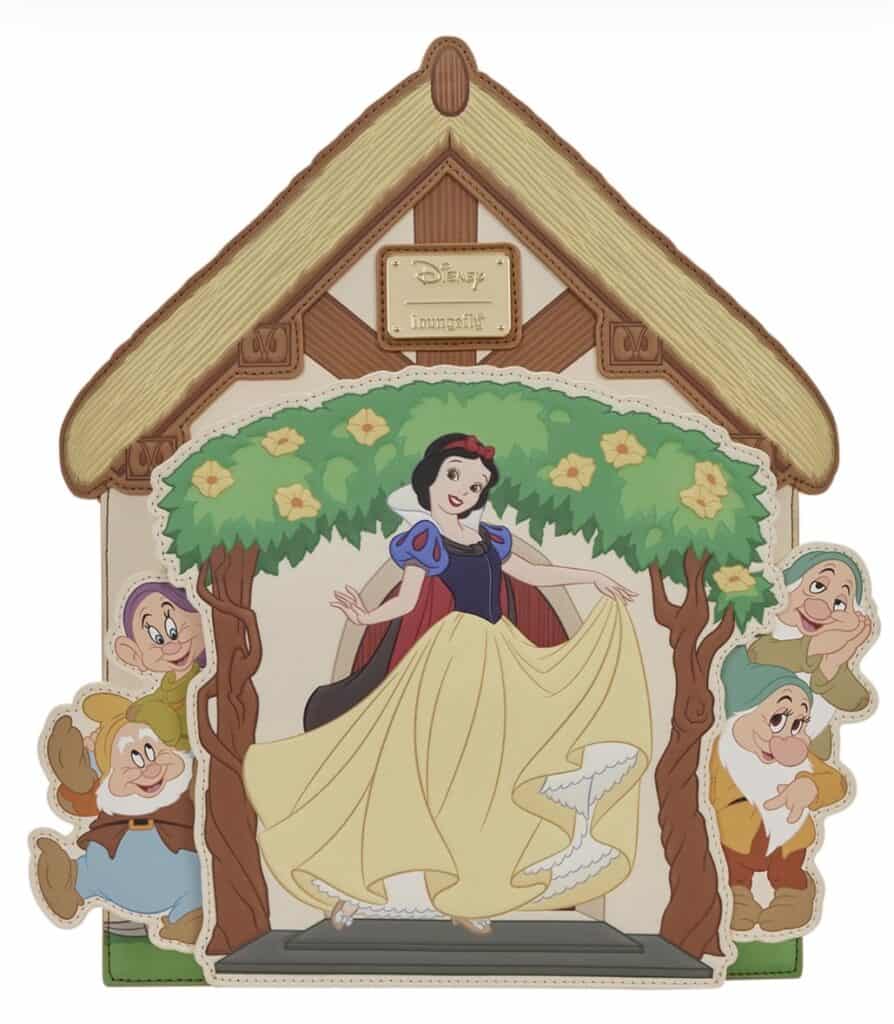 Snow White figurine display with Disney Princess characters and cottage backdrop.