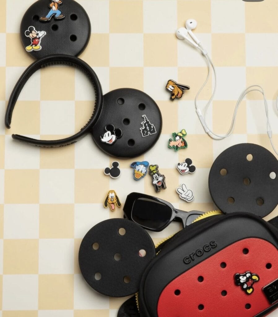 Mickey Mouse themed accessories including earphones, pins, and cases for Disney fans.