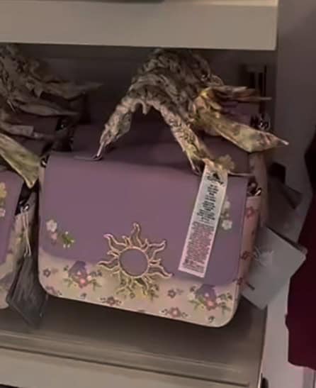 Disney princess purse with floral pattern and sun emblem, perfect for fans of Disney fashion accesso.