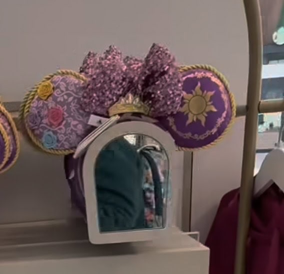 Minnie Mouse ears headband with purple and pink floral details.