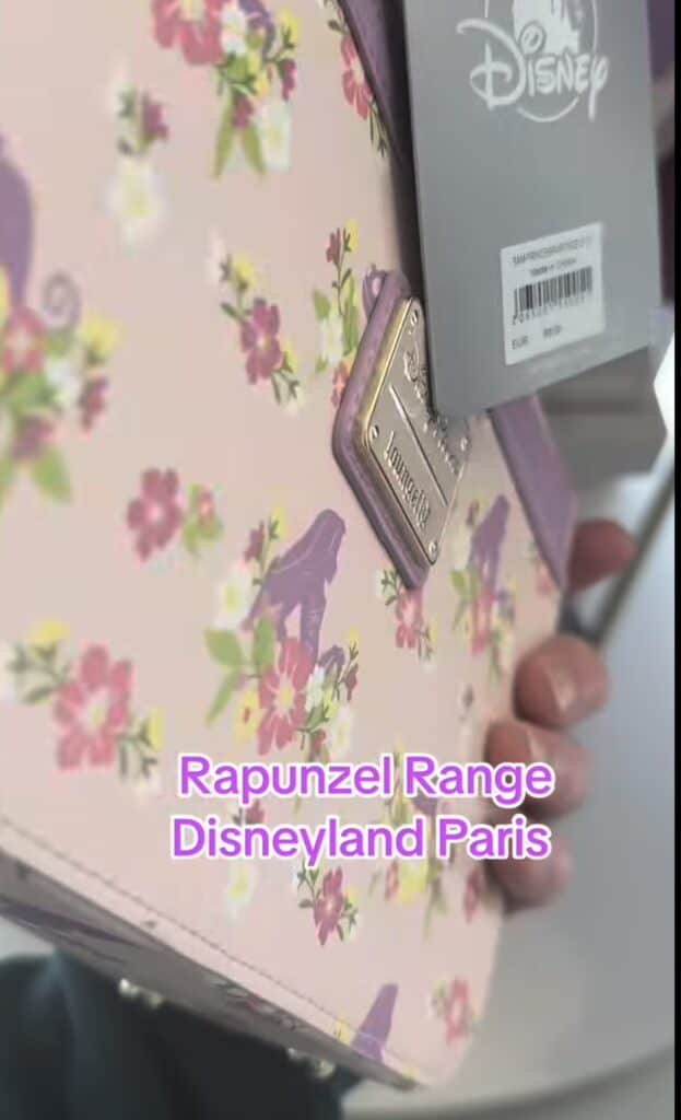 Disney Rapunzel-themed backpack featuring floral patterns and a gold logo detail.