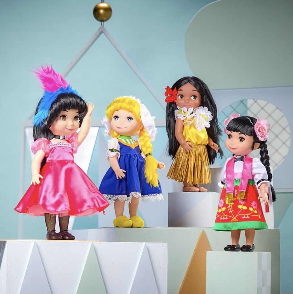 Four Disney Fashionista dolls in colorful outfits on display.