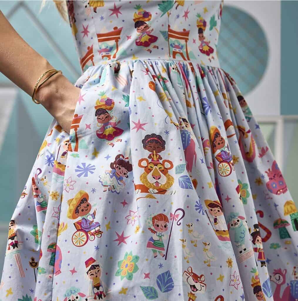Colorful Disney princess dress featuring various characters and playful patterns.