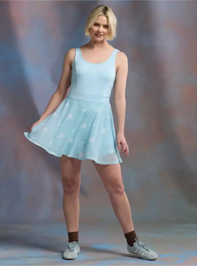 Woman wearing a light blue Disney-themed dress with a flared skirt.