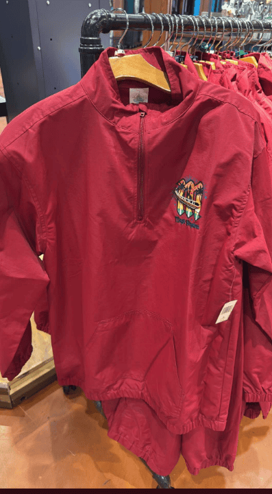 Red Disney-themed jacket with colorful embroidered design on the chest.