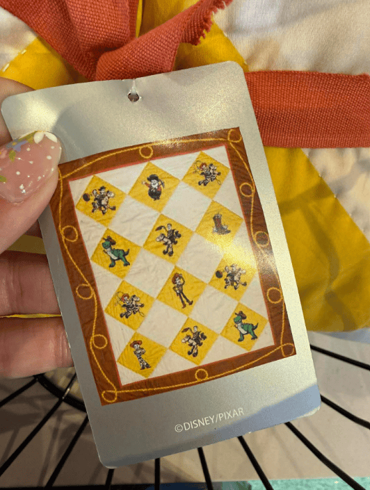 Disney Pixar character toy tag with colorful design and characters.