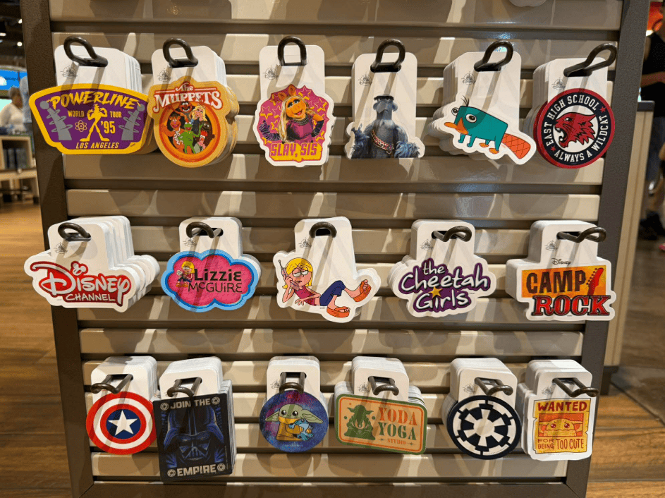 Disney character-themed keychains on a retail display rack.