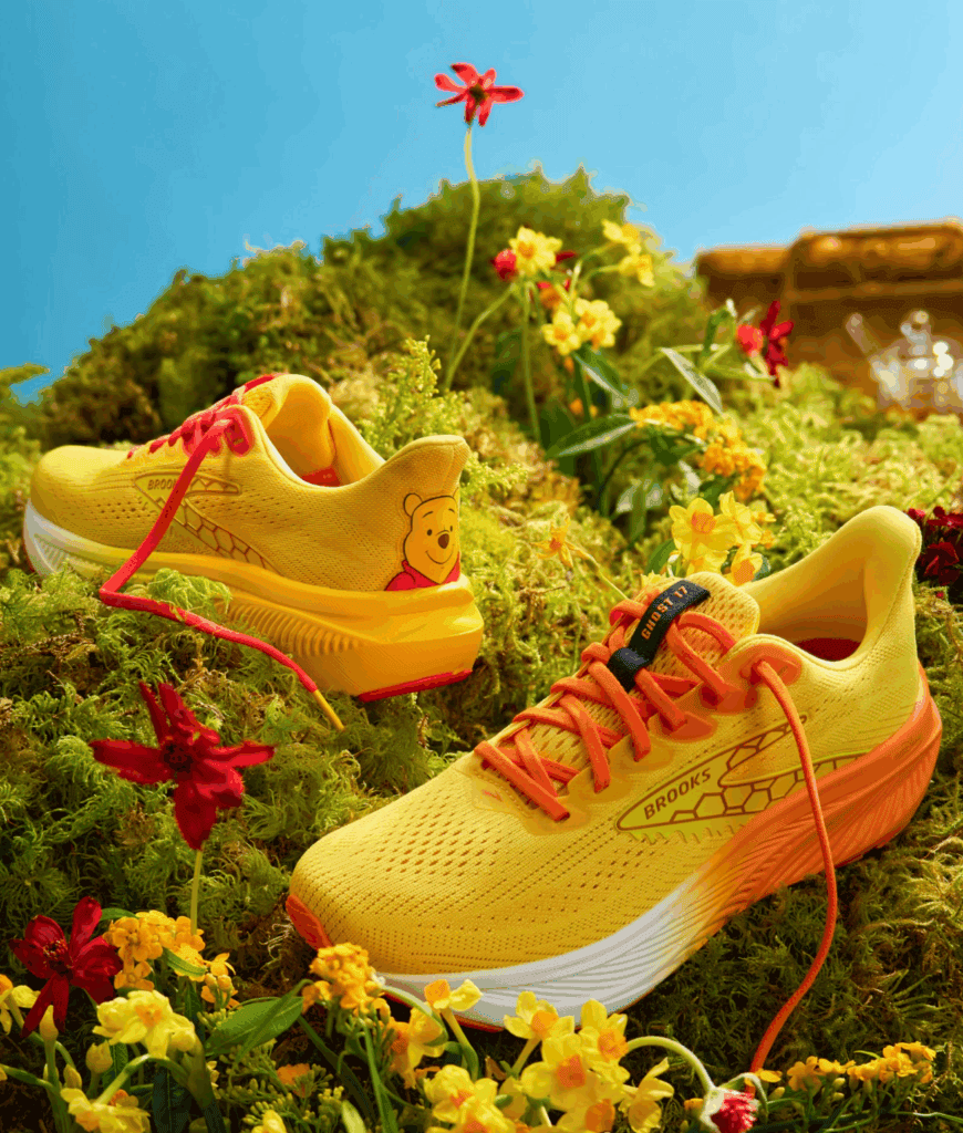 Disney-themed Brooks running shoes with Winnie the Pooh design.