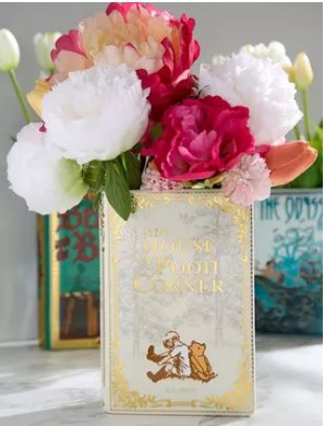 Beautiful floral display featuring pink and white peonies with a "The Disney Shop" sign.