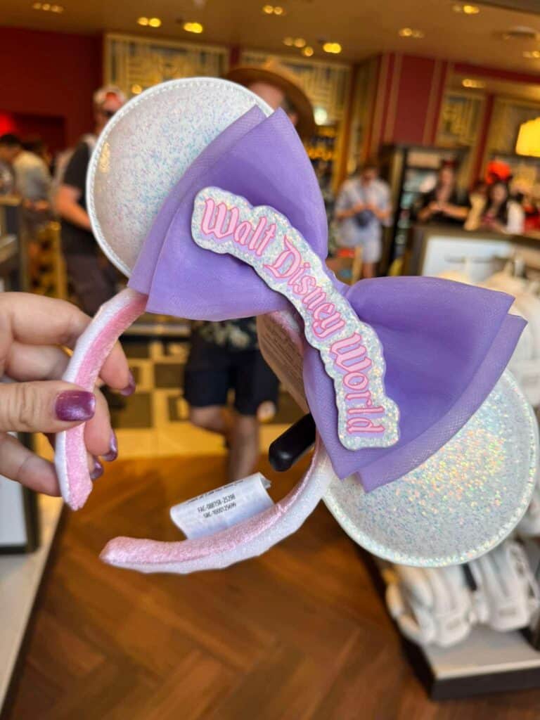 Disney World Minnie Mouse ears headband with purple bow and glittery ears.