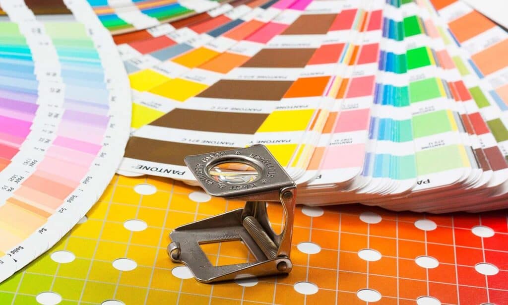 Bunt bedruckte Farbtafeln und Messwerkzeug für Druck- und Designarbeiten.