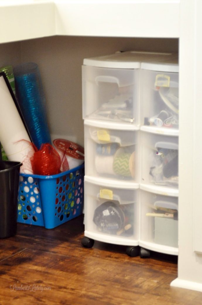 plastic drawer bins under a desk.