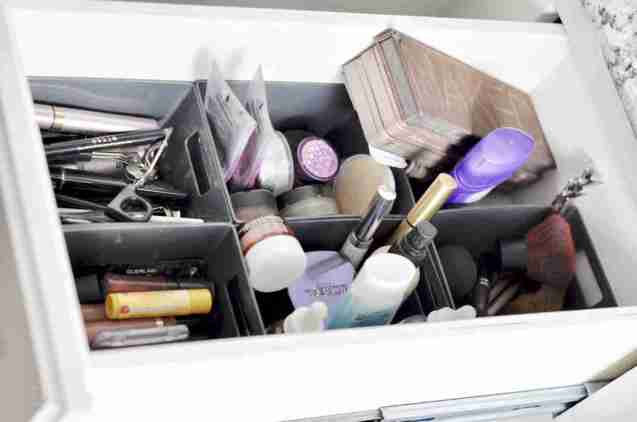 makeup organized into baskets in a drawer.