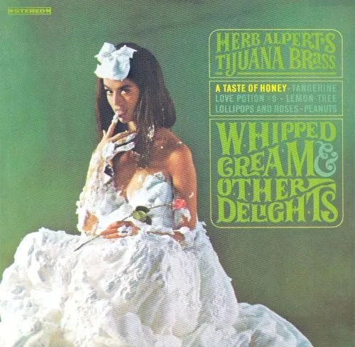 Woman sitting in a dress made of whipped cream.