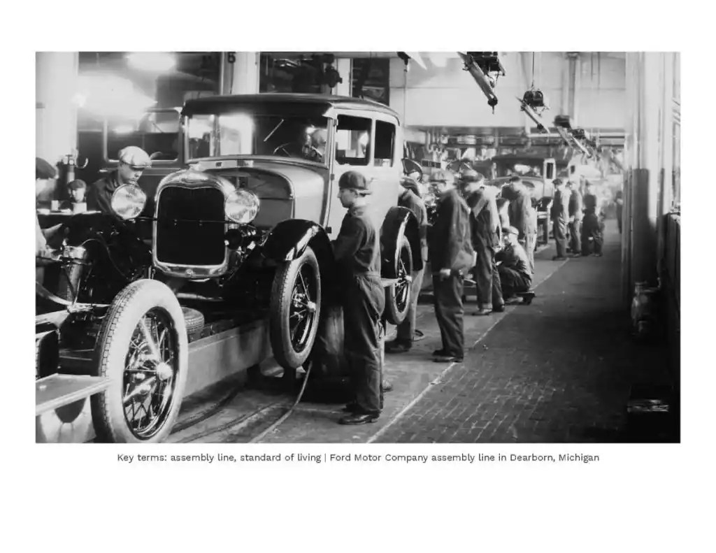 Assembly line workers inspecting classic Ford Model T cars in a factory setting.