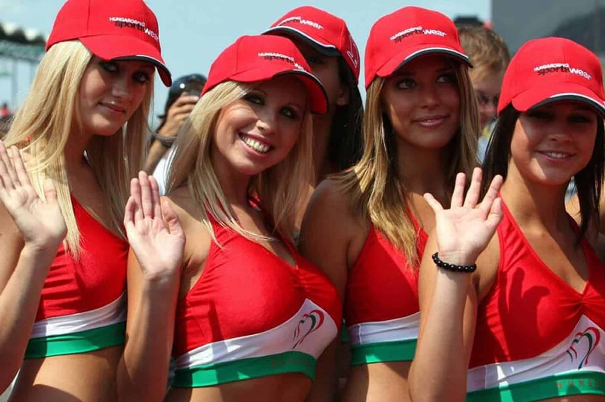 Hungarian Grand Prix grid girls in red uniforms waving at Budapest F1 event