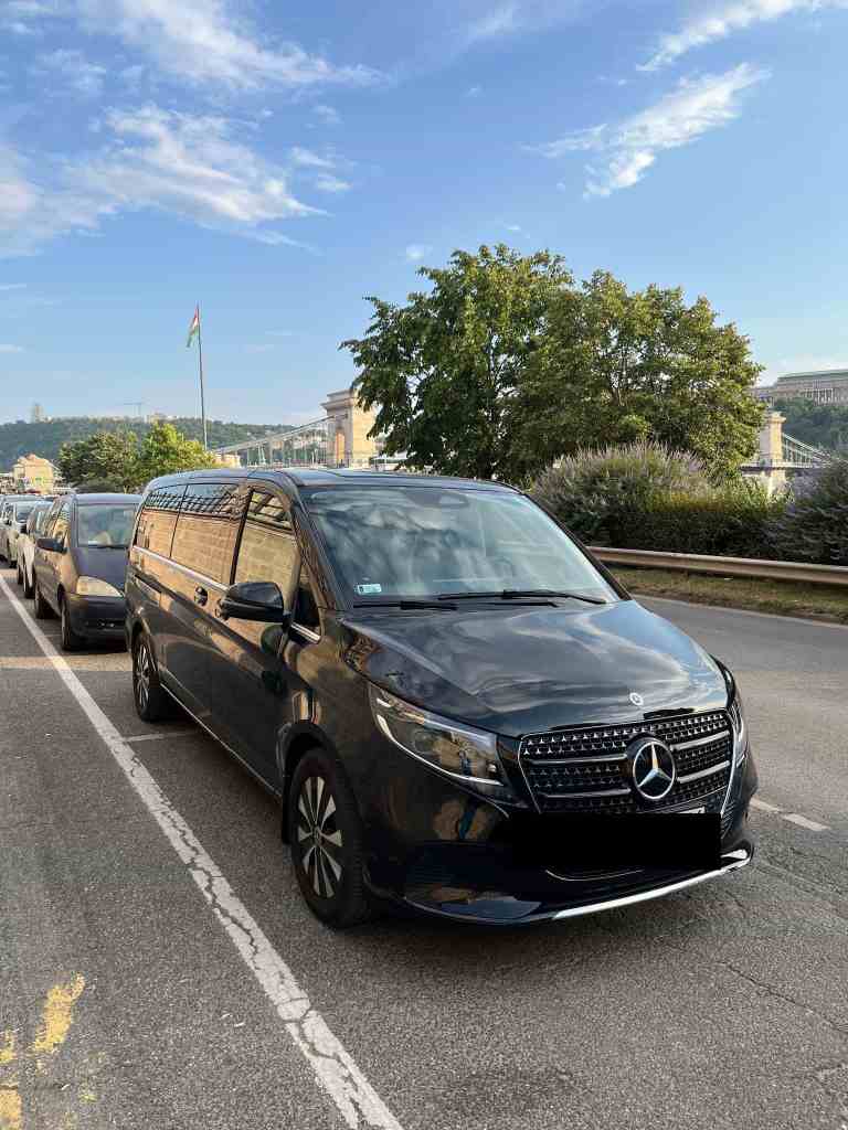 Luxury Mercedes private transfer vehicle parked in Budapest with Chain Bridge visible in background