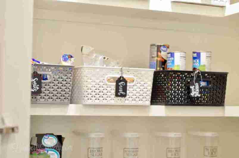 plastic baskets on a shelf in a pantry.