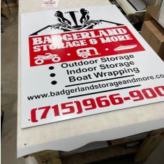 Baderland Storage & More sign showcasing outdoor storage, indoor storage, boat wrapping, and trailer dealership services at I39 Supply.