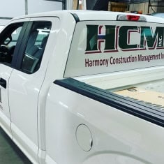 White pickup truck with I39 Supply logo and "Harmony Construction Management" branding, showcasing a trailer dealership vehicle at I39 Supply.