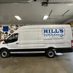 White Hills Wiring service van parked indoors at I39 Supply trailer dealership, showcasing professional commercial vehicle for wiring and trailer sales.