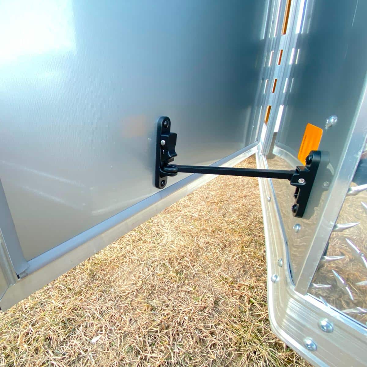 Close-up of trailer door lock mechanism at I39 Supply trailer dealership, showcasing secure latch system for safe transportation.