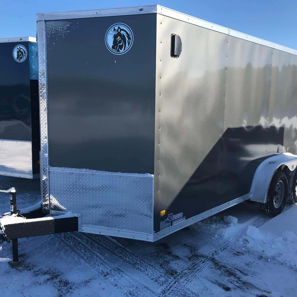 High-quality enclosed cargo trailer for sale at I39 Supply, perfect for transportation and storage needs. Durable construction with sleek black finish and logo branding.