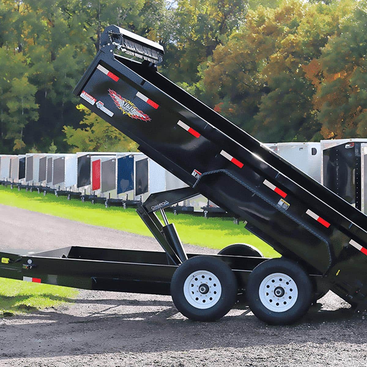 Black tilt trailer for sale at I39 Supply trailer dealership, ideal for transporting equipment and vehicles, with durable construction and easy loading features.
